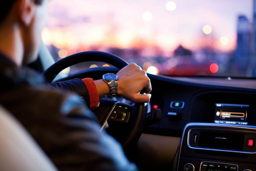 Person driving a car on an open road
